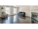 Bright living room featuring fireplace, hardwood floors, and large windows at 249 The South Chace Ne, Atlanta, GA 30328