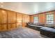Spacious living room with wood-paneled walls and a comfortable gray sectional couch at 249 The South Chace Ne, Atlanta, GA 30328