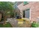 Outdoor brick patio featuring a small table set, a grill, and access to the house via a sliding door at 249 The South Chace Ne, Atlanta, GA 30328