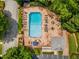 Aerial view of community pool featuring lounge chairs and tables surrounded by mature trees and greenery at 249 The South Chace Ne, Atlanta, GA 30328