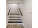 Staircase with white risers, dark treads, and wood-look flooring at the base at 249 The South Chace Ne, Atlanta, GA 30328
