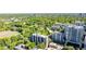 Aerial view of property surrounded by lush green trees and featuring a serene lake, ideal for peaceful living at 275 13Th Ne St # 903, Atlanta, GA 30309