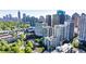 Stunning aerial view of a condo community with lush green trees and a beautiful city skyline in the background at 275 13Th Ne St # 903, Atlanta, GA 30309