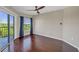 Relaxing bedroom with hardwood floors, ceiling fan, and access to a private balcony at 275 13Th Ne St # 903, Atlanta, GA 30309