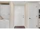 Entryway with a stacked washer/dryer, white door with gold knob, and dark hardwood flooring at 275 13Th Ne St # 903, Atlanta, GA 30309