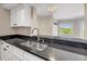 Updated kitchen offers stainless steel appliances, sleek dark countertops, and hardwood flooring at 275 13Th Ne St # 903, Atlanta, GA 30309