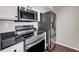 Close up of the stainless steel appliances and sleek dark countertops in the kitchen at 275 13Th Ne St # 903, Atlanta, GA 30309