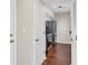 Galley-style kitchen features stainless steel appliances, dark countertops, and hardwood floors at 275 13Th Ne St # 903, Atlanta, GA 30309