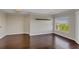 Large living room features hardwood floors, neutral walls, and a large window with natural light at 275 13Th Ne St # 903, Atlanta, GA 30309