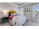 Cozy bedroom with a colorful bed, bright windows, modern decor, and horse-themed artwork at 304 Oldvine Dr, Lawrenceville, GA 30044