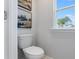 Bright toilet with a window and decorations on the wall at 306 Oldvine Dr, Lawrenceville, GA 30044