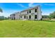 Beautifully manicured backyard showcasing a modern two-story home with dark framed windows at 376 Waterbluff Dr, Mableton, GA 30126