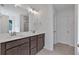 Bathroom featuring double vanity sinks, a well lit mirror and a separate shower with glass doors at 376 Waterbluff Dr, Mableton, GA 30126