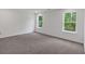 Bright, neutral-colored bedroom with plush carpet and views of lush, green backyard space at 376 Waterbluff Dr, Mableton, GA 30126