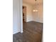 Elegant dining area with wainscoting, hardwood floors, and a modern chandelier, offering a view into the kitchen at 376 Waterbluff Dr, Mableton, GA 30126