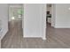 The open-concept floor plan features wood-look flooring and a view of the kitchen and dining area at 376 Waterbluff Dr, Mableton, GA 30126