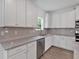 Well-lit kitchen featuring white cabinets, stainless steel appliances, and gray countertops at 376 Waterbluff Dr, Mableton, GA 30126