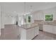 Open kitchen with island, stainless appliances, and view into the living room with fireplace at 376 Waterbluff Dr, Mableton, GA 30126