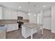 Open-concept kitchen boasts a kitchen island, stainless steel appliances, and stylish pendant lighting at 376 Waterbluff Dr, Mableton, GA 30126