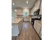 The kitchen showcases granite countertops, stainless steel appliances, and ample storage at 376 Waterbluff Dr, Mableton, GA 30126