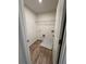 Efficient laundry room with wood-look flooring, wire shelving and washer hookups at 376 Waterbluff Dr, Mableton, GA 30126