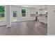 An open-concept living space has hard surface floors and features an open view into the kitchen at 376 Waterbluff Dr, Mableton, GA 30126