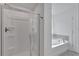 Modern main bathroom with walk-in shower and separate soaking tub with stylish fixtures at 376 Waterbluff Dr, Mableton, GA 30126