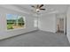 Large main bedroom with tray ceiling, ceiling fan, and sun-filled windows showing backyard views at 376 Waterbluff Dr, Mableton, GA 30126
