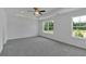 Spacious main bedroom featuring a ceiling fan and multiple bright windows overlooking green space at 376 Waterbluff Dr, Mableton, GA 30126