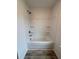Shower and tub area featuring a white acrylic surround with built in storage shelving at 376 Waterbluff Dr, Mableton, GA 30126