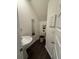 Charming bathroom with stylish pedestal sink, dark wood floors, and modern decor at 1302 Speckle Park Way, Stockbridge, GA 30281