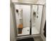 Modern bathroom shower with glass doors, bench seat, and sleek fixtures at 1302 Speckle Park Way, Stockbridge, GA 30281