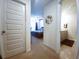 Open doorway view into a bedroom with ceiling fan and bathroom featuring a double vanity at 1302 Speckle Park Way, Stockbridge, GA 30281