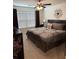 Comfortable bedroom with a ceiling fan, window and luxurious bedding at 1302 Speckle Park Way, Stockbridge, GA 30281