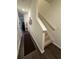 Bright hallway with hardwood floors leads to the staircase and other areas of the home at 1302 Speckle Park Way, Stockbridge, GA 30281