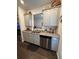Modern kitchen with granite countertops, stainless steel appliances, and gray cabinetry at 1302 Speckle Park Way, Stockbridge, GA 30281