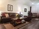 Comfortable living room with hardwood floors, leather seating, and neutral decor at 1302 Speckle Park Way, Stockbridge, GA 30281