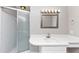 This bathroom features a shower with sliding doors, a white vanity with a sink, and a mirror with lighting at 1507 Fair Haven Dr, Riverdale, GA 30296