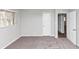 Bedroom with gray carpet, white walls, and a bright window at 1507 Fair Haven Dr, Riverdale, GA 30296