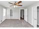 Bedroom features ceiling fan, new carpet, and ensuite bathroom at 1507 Fair Haven Dr, Riverdale, GA 30296
