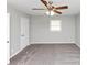 Bedroom features new carpet, ceiling fan, and natural light at 1507 Fair Haven Dr, Riverdale, GA 30296