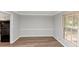 Bright dining room with hardwood floors and a large window at 1507 Fair Haven Dr, Riverdale, GA 30296