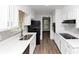 Well-lit kitchen with white cabinets, stainless steel appliances, and hardwood floors at 1507 Fair Haven Dr, Riverdale, GA 30296