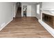 Living room with painted fireplace and hardwood floors at 1507 Fair Haven Dr, Riverdale, GA 30296