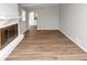 Living room with painted fireplace, hardwood floors, and ample natural light at 1507 Fair Haven Dr, Riverdale, GA 30296