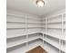 Spacious pantry features wooden floors and custom shelving at 1507 Fair Haven Dr, Riverdale, GA 30296