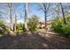 Large backyard with mature trees, lush landscaping, and exterior view of house at 2265 E Lake Ne Rd, Atlanta, GA 30307