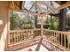 An open-air balcony with wood-beamed pergola and tiled flooring, overlooking mature trees at 2265 E Lake Ne Rd, Atlanta, GA 30307