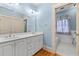 Modern bathroom features a double sink vanity, blue walls, and tile accents at 2265 E Lake Ne Rd, Atlanta, GA 30307