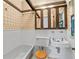 Cozy bathroom featuring classic fixtures, patterned wallpaper, a tub, and a toilet at 2265 E Lake Ne Rd, Atlanta, GA 30307